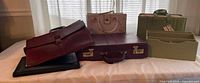 All six office items displayed on table: briefcases, portfolio, file tote, desk caddy