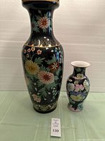 Large and small cloisonné vases side by side with lot tag visible