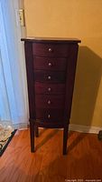 Full frontal view of dark cherry jewelry armoire