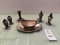Full lot view with gravy boat, four shakers, two candlesticks