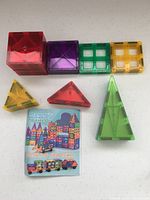 Assorted shapes and colours of magnetic tiles with instruction booklet