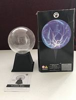 Plasma globe on base with original box and instruction sheet visible