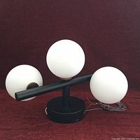 Front view of Artika Bloom flush mount showing three glass globes and black base