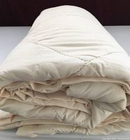 Comforter rolled showing thickness and quilting