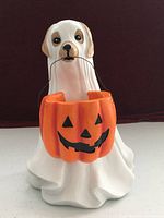 Front view of ghost dog figurine holding pumpkin bucket