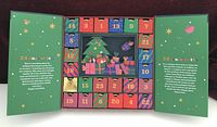 Calendar opened showing 24 numbered drawers around central festive graphic