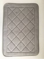 Full top view of dark gray diamond-quilted bath mat