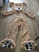 Full view of unstuffed teddy bear cover laid flat showing overall size and shape