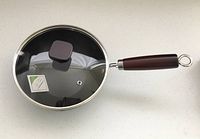 Wok assembled with lid and handle attached