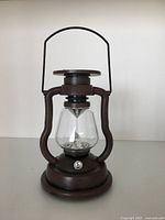 Lantern unlit showing overall design, handle, globe, base
