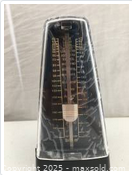 Front view showing tempo scale and pendulum