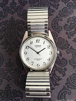 Front view showing dial, hands, bracelet