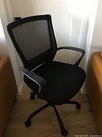 Full side view showing mesh back, seat, base, armrest