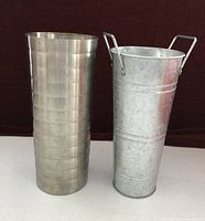 Two metal containers standing side by side
