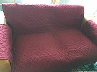 Sofa cover installed on yellow sofa showing fit and diamond stitching