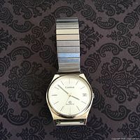 Front view of watch on patterned background