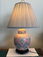 Full view of lamp with shade on wooden base