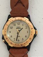 Close view of dial, bezel, and strap attachment