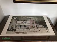 Full view of unframed print on table showing entire image and margins