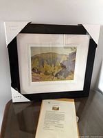 Framed print with certificate on table
