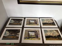 All six unframed A.J. Casson prints displayed on table