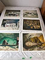 Six different A.J. Casson 20 x 24 in prints displayed unframed