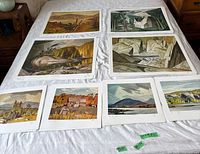 Eight prints laid out on bed showing full assortment