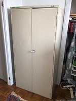 Full front view of beige metal cabinet with double doors