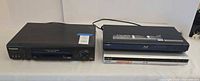 Panasonic VCR, Sony Blu-ray player stacked over Sony DVD recorder
