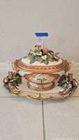 Front view of assembled tureen on underplate showing overall design and colors