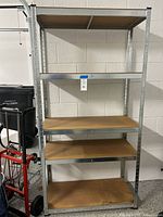 Front view of one metal shelving unit showing all five shelves in place