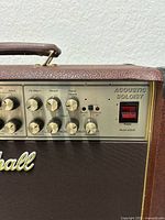 Control panel right side showing Acoustic Soloist badge, input/output jacks, knob layout