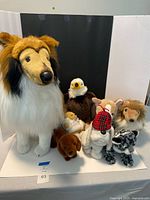 Front view of all eight plush animals grouped together