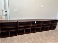 Front view of four of the brown bookcases lined up