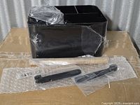Unassembled shower caddy body, wooden handle rod, two black handle brackets and screws, factory wrap
