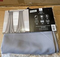 Boxed curtain set showing brand, product line, size, image of installed curtains