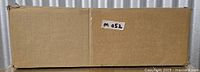 Sealed rectangular cardboard box with small lot label
