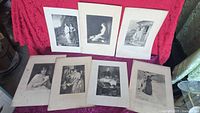 All seven unframed engravings laid out together