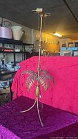 Full view of brass palm tree lamp base showing height, fronds, dual socket, three-leg base
