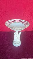 Full view of porcelain compote on figural pedestal
