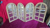 Front view showing four arched panels with mirror panes