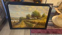 Front view of framed landscape painting