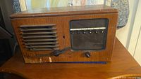 Front view of wooden Teletalk radio showing speaker grille, tuning window, knob