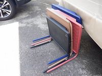 Four nested adjustable tray tables showing colors and leg structure