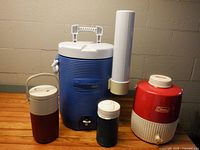 Group shot of all four beverage coolers and cup dispenser