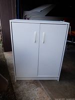 Front view of closed white 2-door cabinet