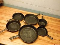 Six cast iron pans front view