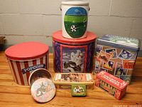 All eight tins grouped on wooden surface