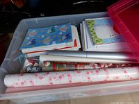 Open clear tote showing wrapping paper rolls, cards and tissue