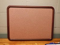 Front of burgundy fabric push pin board